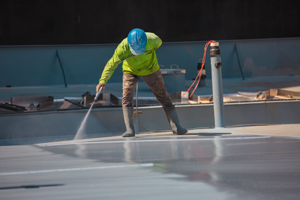 man applying industrial coatings